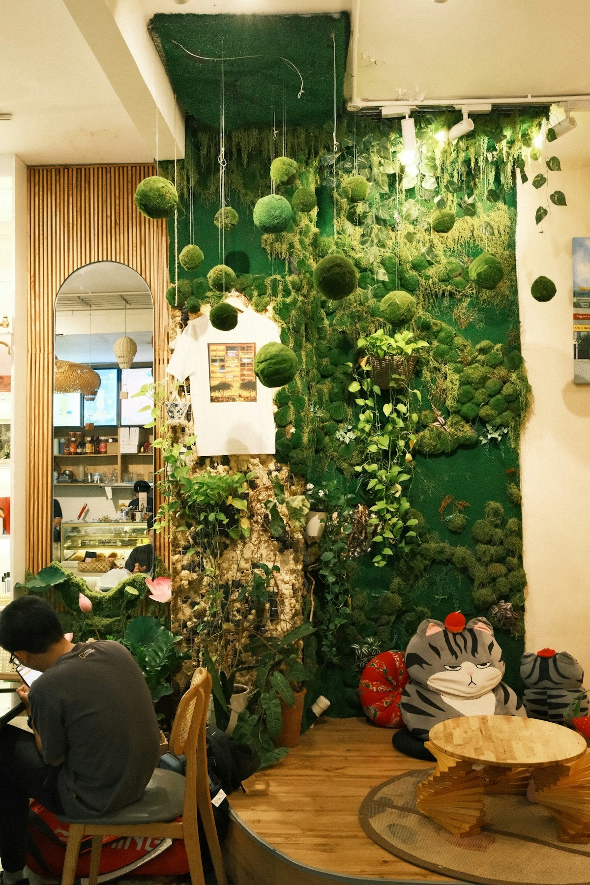 A beautifully made kokedama — a living plant sculpture wrapped in natural fiber — presented as a meaningful gift